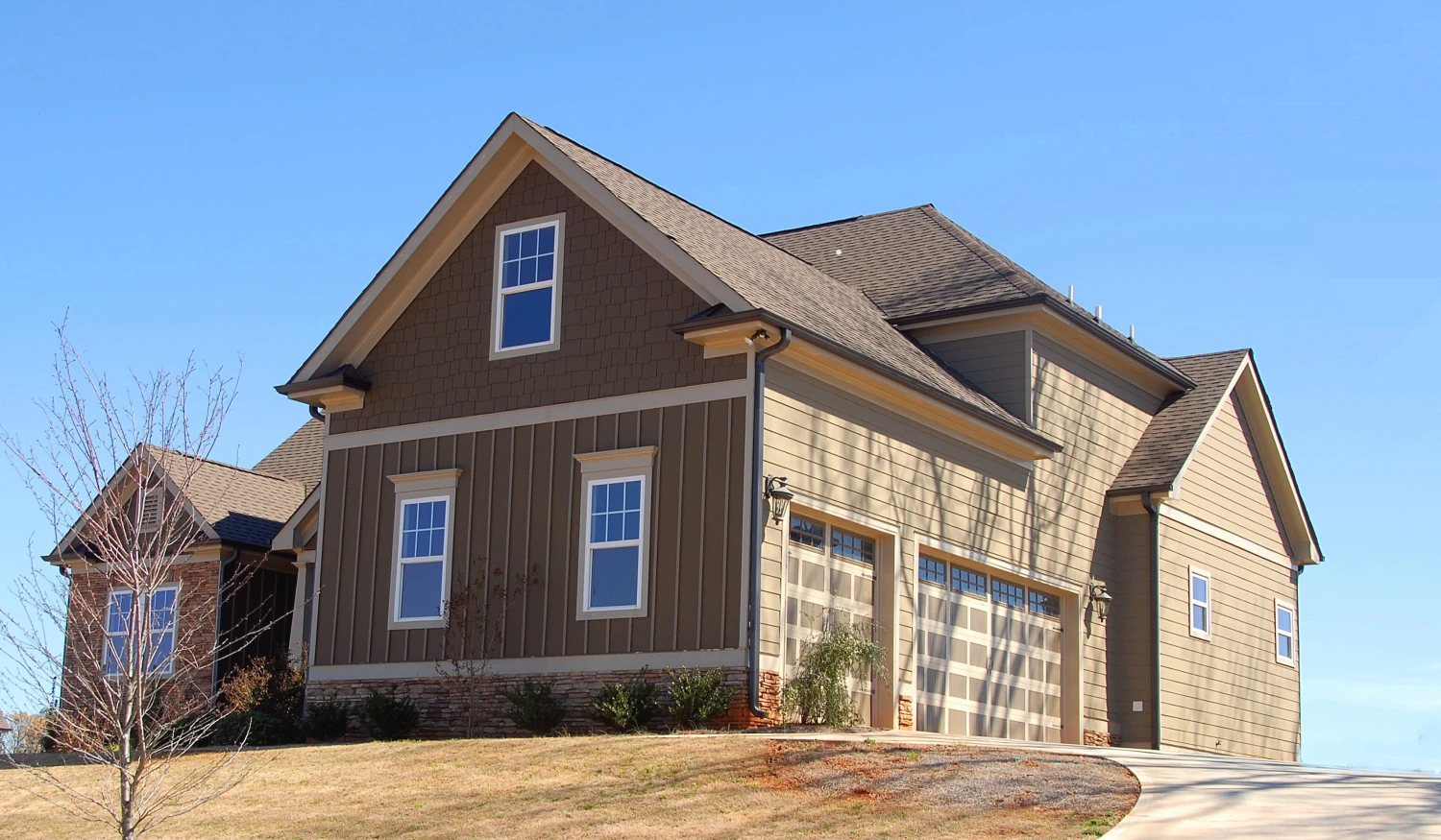 A house with a garage on the side of it.
